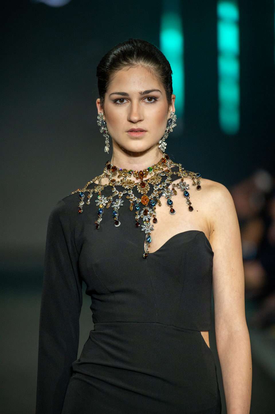 Female model wearing Topaz or Golden Shadow statement earrings and a luxurious Baroqco necklace, styled with a black dress from Blue Valentine for Alta Roma 2024. The jewelry features Swarovski crystals, genuine CRYSTAL®, semi-precious stones, and freshwater pearls, set in recycled silver or gold plating—nickel-free. A true embodiment of luxury, haute couture, and regal elegance.